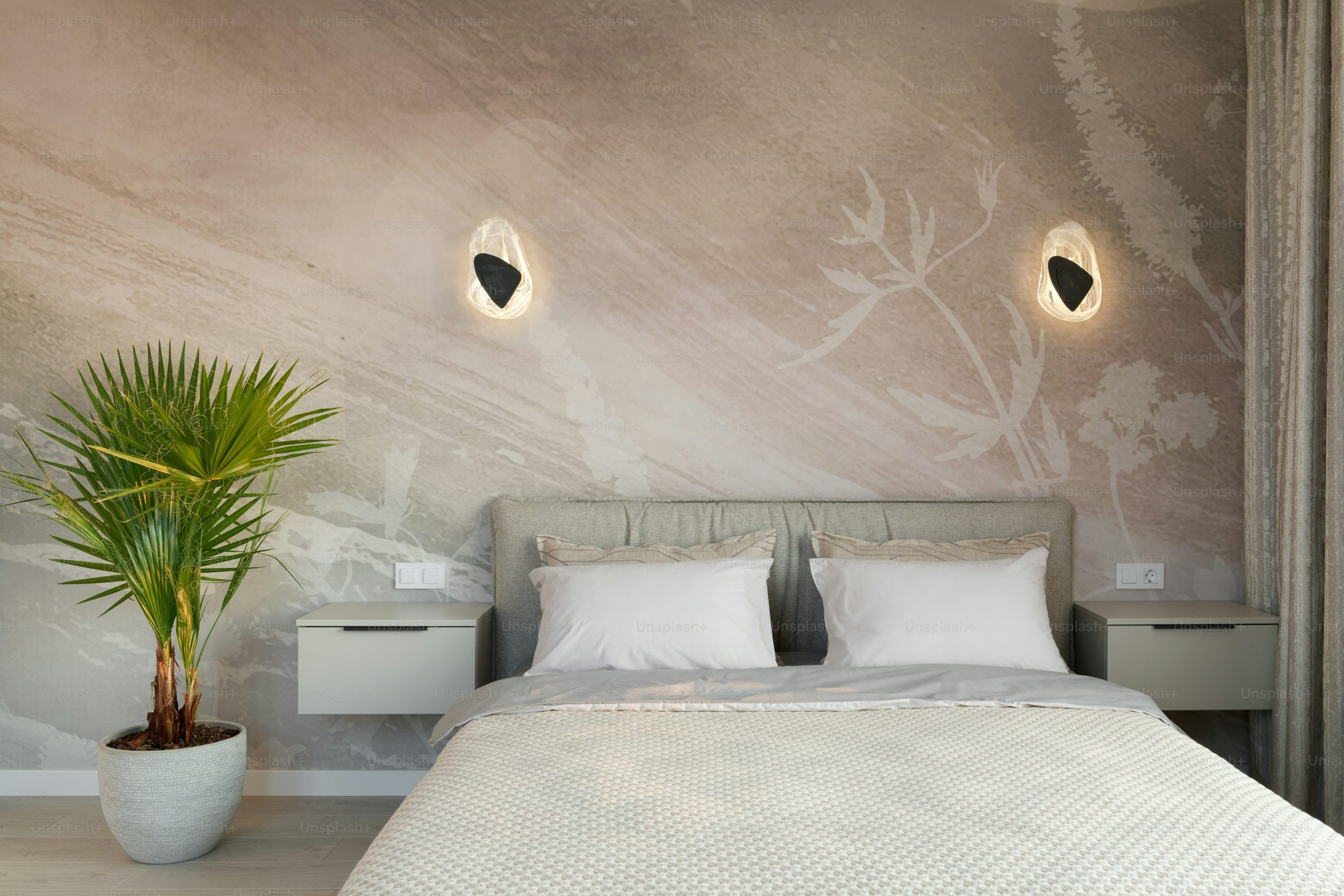Oversized pale blue floral wallcovering above a bed