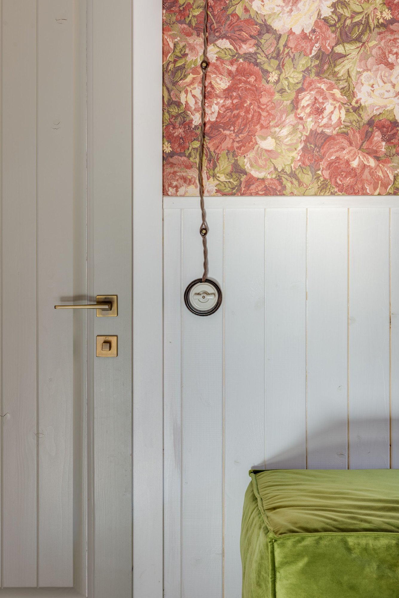 Botanical wallpaper meeting white wooden trim in an interior